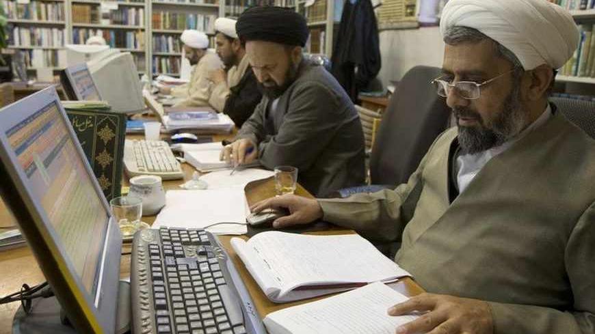 Clerics work on computers at a religious research center associated with the seminary in Qom, 120 km (75 miles) south of Tehran February 2, 2009.     REUTERS/Caren Firouz  (IRAN) - RTXB5VD