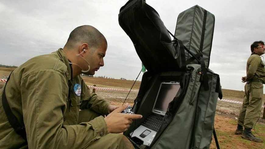 Israeli soldiers from Rafael- Israel's Armament Development Authority, fly the new drone (remote-piloted vehicle), during a demonstration for the Israel Defence Forces In Gahash near Tel Aviv November 21, 2005. The new drone is part of the "SkyLite" family of mini remote-piloted vehicles that gather intelligence for field and special forces using an electro optic sensor. - RTXNAV6