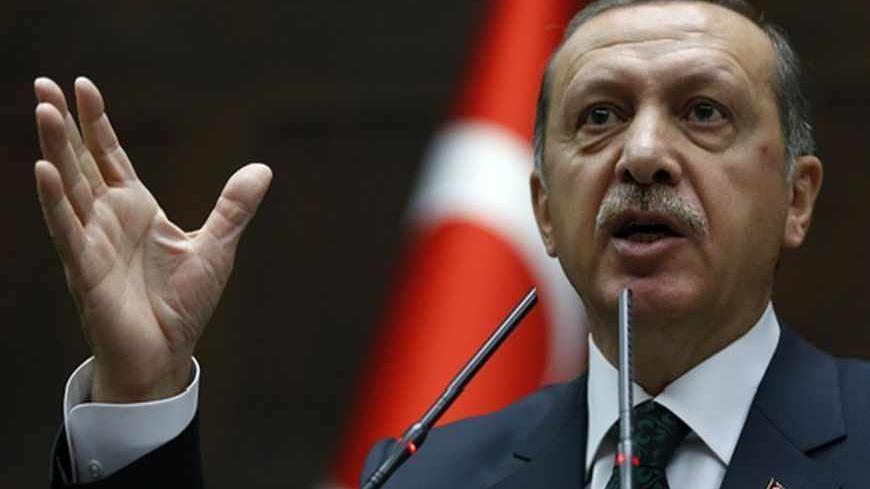 Turkey's Prime Minister Tayyip Erdogan addresses members of parliament from his ruling AK Party (AKP) during a meeting at the Turkish parliament in Ankara June 25, 2013. Turkish anti-terrorism police detained 20 people in raids in the capital Ankara on Tuesday in connection with weeks of anti-government protests across the country, media reports said. The unrest began at the end of May when police used force against campaigners opposed to plans to redevelop a central Istanbul park. The protest spiralled int