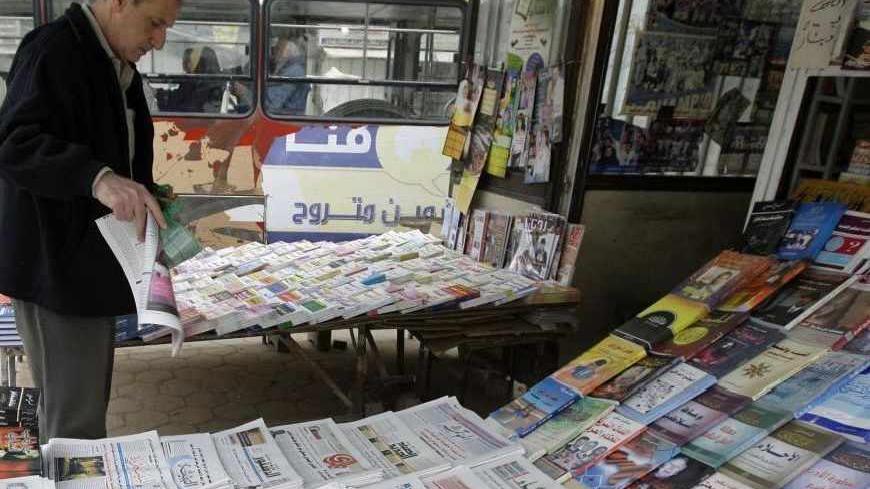 A resident buys a newspaper from a kiosk in Baghdad February 23, 2009. A boom in local media since the U.S.-led invasion in 2003 has given Iraqis a choice between some 200 print outlets, 60 radio stations and 30 TV channels in Arabic, Turkmen, Syriac and two Kurdish dialects. Yet most media outlets remain dominated by sectarian and party patrons who use them for their own ends, and have yet to become commercially sustainable enterprises let alone watchdogs keeping government under scrutiny, the favoured Wes