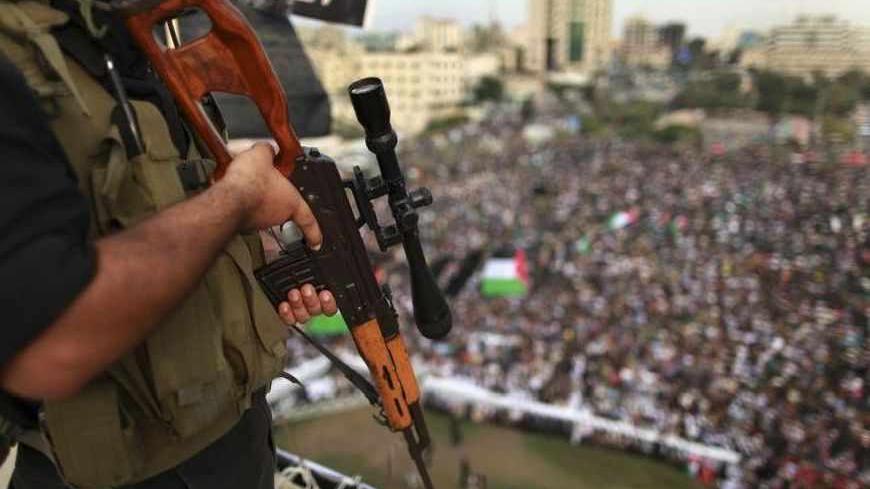 An Islamic Jihad militant stands guard during a rally marking the 25th anniversary of the movement's foundation in Gaza City October 4, 2012. REUTERS/Suhaib Salem (GAZA - Tags: POLITICS CIVIL UNREST ANNIVERSARY) - RTR38SLK