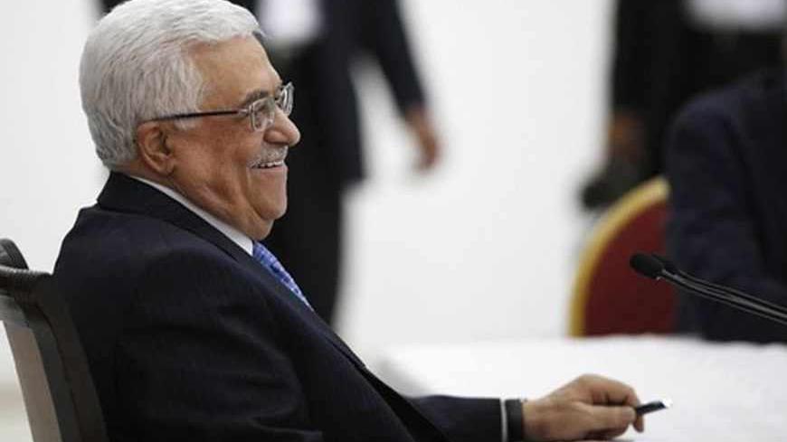 Palestinian President Mahmoud Abbas smiles during a meeting of the Palestinian leadership in the West Bank city of Ramallah July 18, 2013. As Palestinian leaders discussed a possible U.S-brokered resumption of peace talks on Thursday, the Israeli government denied a shift in its conditions that might help end a three-year stalemate. Abbas began briefing fellow PLO leaders in Ramallah on his meetings this week with U.S. Secretary of State John Kerry, who has extended his stay in the region and appears to be 