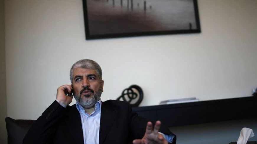 Hamas leader Khaled Meshaal uses his mobile phone in his office in Doha November 29, 2012. Meshaal said the de facto recognition of a sovereign Palestinian state won by his rival Mahmoud Abbas should be seen alongside Gaza's latest conflict with Israel as a single, bold strategy that could empower all Palestinians. Meshaal said the short war which claimed 162 Palestinian lives and five Israelis was concluded on terms set by the Palestinian Islamist movement and ended its isolation, creating a new mood that 