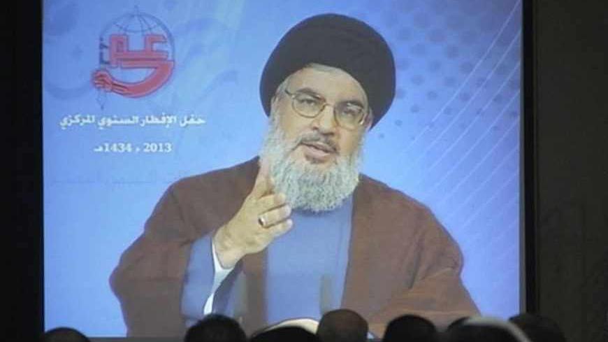 Lebanon's Hezbollah leader Sayyed Hassan Nasrallah addresses his supporters via a video conference during iftar, the breaking of fast meal, during the Islamic month of Ramadan in Beirut's southern suburbs July 19, 2013. REUTERS/Sharif Karim   (LEBANON - Tags: POLITICS RELIGION) - RTX11S9O