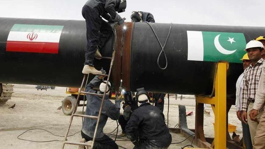 Irani workers weld the pipeline during a groundbreaking ceremony to mark the inauguration of the Iran-Pakistan gas pipeline, in the city of Chahbahar in southeastern Iran March 11, 2013. Ahmadinejad and Zardari marked the start of Pakistani construction on the much-delayed gas pipeline on Monday, Iranian media reported, despite U.S. pressure on Islamabad to back out of the project. REUTERS/Mian Khursheed  (IRAN - Tags: POLITICS ENERGY BUSINESS) - RTR3EUST