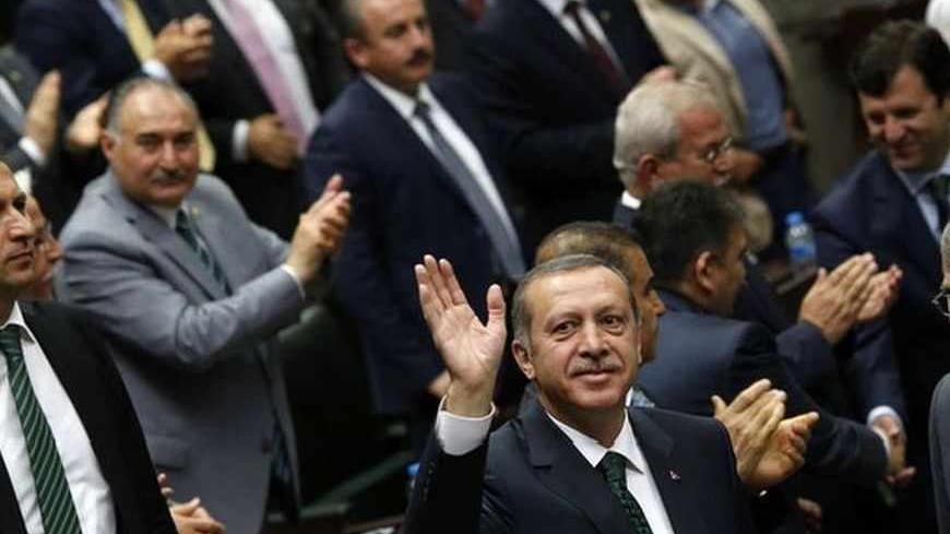 Turkey's Prime Minister Tayyip Erdogan (C) greets members of parliament from his ruling AK Party (AKP) during a meeting at the Turkish parliament in Ankara  June 25, 2013. Turkish anti-terrorism police detained 20 people in raids in the capital Ankara on Tuesday in connection with weeks of anti-government protests across the country, media reports said. The unrest began at the end of May when police used force against campaigners opposed to plans to redevelop a central Istanbul park. The protest spiralled i