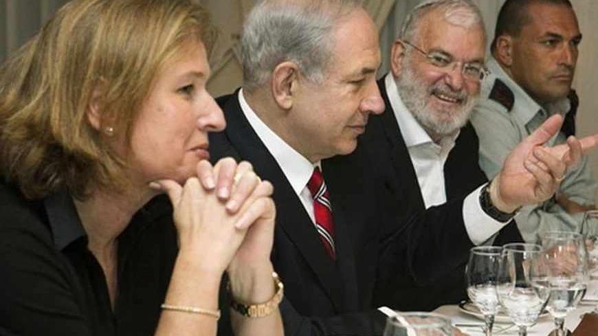 Israel's Prime Minister Benjamin Netanyahu (2nd L), flanked by Tzipi Livni (L), Israel's chief negotiator with the Palestinians, National Security Adviser Yaakov Amidror (3rd L) and Military Secretary Eyal Zamir, speaks with U.S. Secretary of State John Kerry (not pictured) during a meeting in Jerusalem June 29, 2013. Kerry extended his Middle East peace mission on Saturday, shuttling between Jerusalem and Amman for more talks with Israeli and Palestinian leaders on reviving their stalled negotiations. REUT