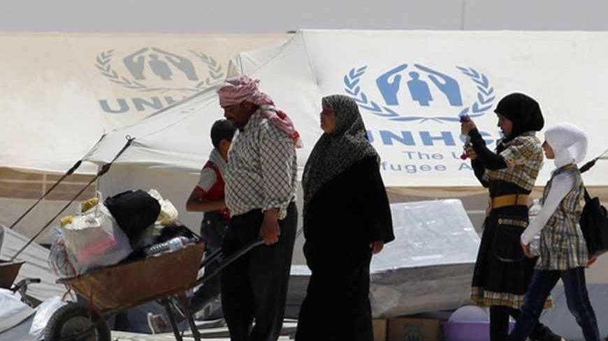 A newly arrived Syrian refugee receives aid and rations, at Al-Zaatri refugee camp in the Jordanian city of Mafraq, near the border with Syria, on World Refugee Day, June 20, 2013. U.N. refugee chief Antonio Guterres, and the Norwegian foreign Minister, Espen Barth Eide, along with United Nations High Commissioner for Refugees (UNHCR) special envoy, actress Angelina Jolie, held a news conference at the camp to commemorate the World Refugee Day, and to urge the world to support refugees in Syria and around t