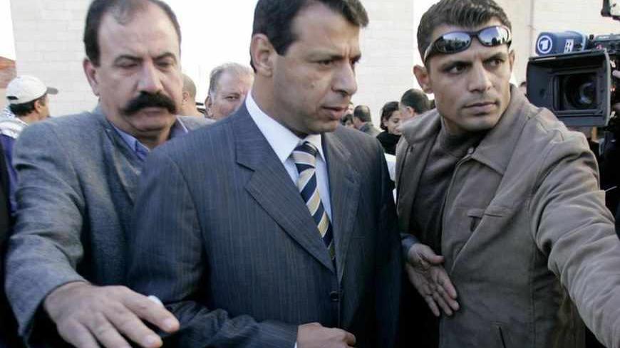 Fatah strongman and lawmaker Mohammed Dahlan (C) arrives at the Palestinian Authority headquarters in the West Bank city of Ramallah December 16, 2006. Hamas spokesman Ismail Rudwan accused Fatah strongman and lawmaker Mohammed Dahlan of being behind the attack on Prime Minister Ismail Haniyeh's convoy.  REUTERS/Loay Abu Haykel (WEST BANK) - RTR1KH1X