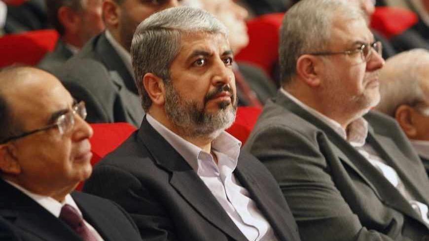 Hamas leader Khaled Meshaal (C), Head of Hezbollah's parliamentary bloc Mohamed Raad (R) and Lebanon's Minister of Education Hassan Mneimneh (L) listen to Lebanon's Hezbollah leader Sayyed Hassan Nasrallah speak via a video display during the Arab and International Forum to support the Resistance, in Beirut January 15, 2010. REUTERS/Jamal Saidi   (LEBANON - Tags: POLITICS) - RTR28WF6