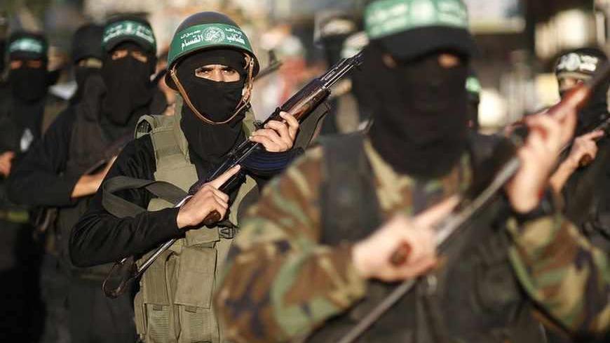 Palestinian members of al-Qassam brigades, the armed wing of the Hamas movement, take part in an anti-Israel parade in Gaza City December 2, 2012. Eight days of Israeli air strikes on Gaza and cross-border Palestinian rocket attacks ended in an Egyptian-brokered truce agreement last month calling on Israel to ease restrictions on the territory. REUTERS/Mohammed Salem (GAZA - Tags: CIVIL UNREST CONFLICT) - RTR3B4SD