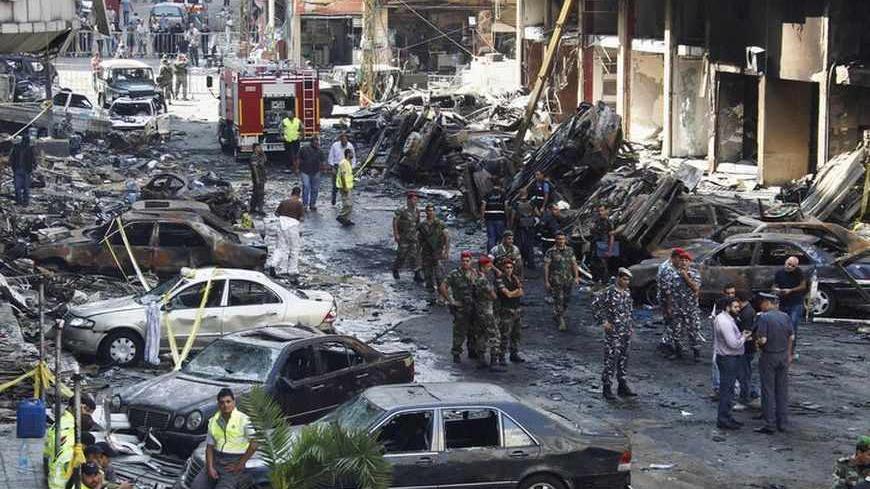 Lebanese army soldiers, military policemen, security forces and Hezbollah members inspect the site of a car bomb that occurred on Thursday in Beirut's southern suburbs, August 16, 2013. The death toll from a car bomb which ripped through the southern Beirut stronghold of Lebanon's militant group Hezbollah rose on Friday to 24, and the government said it was investigating whether the blast was a suicide attack. REUTERS/Sharif Karim   (LEBANON - Tags: POLITICS CIVIL UNREST TPX IMAGES OF THE DAY MILITARY) - RT