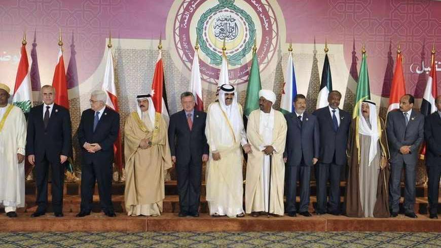 Heads of Arab states gather ahead of a group photo during the opening of the Arab League summit in Doha March 26, 2013. Russia criticised the Arab League on Wednesday for giving a seat formerly held by the Syrian government to a representative of the Syrian opposition at a summit in Doha. Picture taken March 26, 2013. REUTERS/Egyptian Presidency/Handout (EGYPT - Tags: POLITICS) ATTENTION EDITORS - THIS IMAGE WAS PROVIDED BY A THIRD PARTY. FOR  EDITORIAL USE ONLY. NOT FOR SALE FOR MARKETING OR ADVERTISING CA