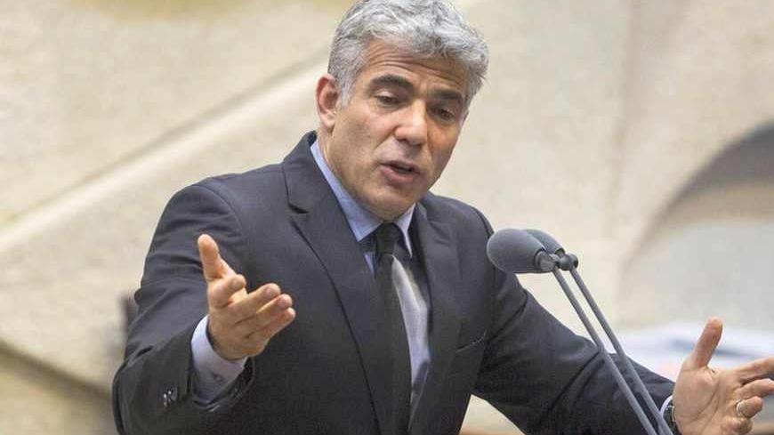 Israel's Finance Minister Yair Lapid gestures as he speaks during the opening of the summer session of the Knesset, the Israeli parliament, in Jerusalem April 22, 2013. Lapid is seeking spending cuts of 18 billion shekels ($5 billion) and tax increases of 5 billion shekels as part of the 2013-2014 budget framework, a spokeswoman for Lapid said on Monday. REUTERS/Baz Ratner (JERUSALEM - Tags: POLITICS BUSINESS) - RTXYVXA