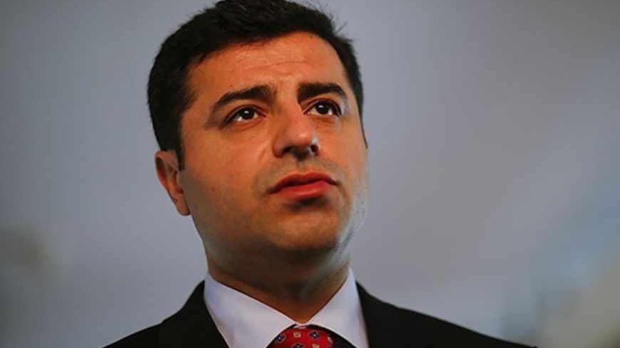 Selahattin Demirtas, co-chairman of the pro-Kurdish Peace and Democracy Party (BDP) answers a question during a Reuters interview in Berlin April 15, 2013. A top Kurdish politician said on Monday it would be difficult for Kurdish fighters to disarm before leaving Turkey under a peace process, stressing that the key issue was that they depart peacefully without contact with the Turkish military. Prime Minister Tayyip Erdogan's government is seeking a weapons-free pullout by militants of the Kurdistan Workers