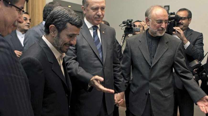 Turkey's Prime Minister Tayyip Erdogan (2nd R) gestures as he welcomes Iranian President Mahmoud Ahmadinejad (2nd L) before holding talks in Istanbul December 22, 2010. They were accompanied by Iran's Foreign Minister Ali Akbar Salehi (L) and Turkish Foreign Minister Ahmet Davutoglu. REUTERS/Tolga Bozoglu/Pool (TURKEY - Tags: POLITICS) - RTXVYLW