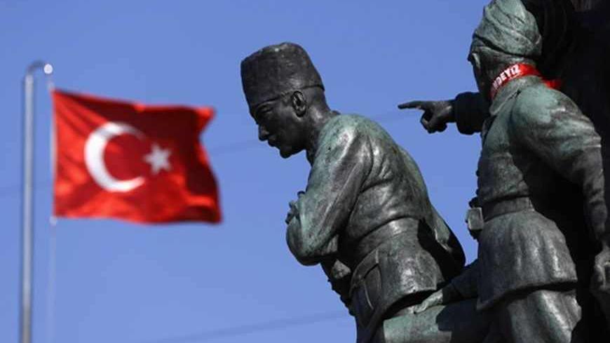 A Turkish flag flutters near the monument of Mustafa Kemal Ataturk at Taksim Square in Istanbul June 24, 2013. REUTERS/Marko Djurica (TURKEY - Tags: SOCIETY) - RTX10Z87
