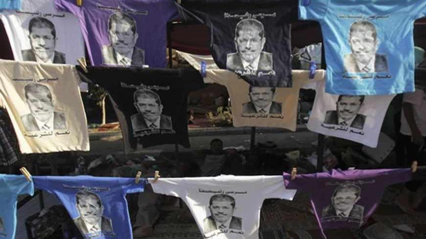 Members of the Muslim Brotherhood and supporters of deposed Egyptian President Mohamed Mursi display T-shirts with pictures of Mursi for sale ahead of Eid al-Fitr celebrations marking the end of the Islamic fasting month of Ramadan from Thursday to Sunday, at Rabaa Adawiya Square, where they are camping, in Nasr City, east of Cairo August 7, 2013. Egypt's political crisis entered a tense new phase on Wednesday after international mediation efforts collapsed and the army-installed government repeated its thr