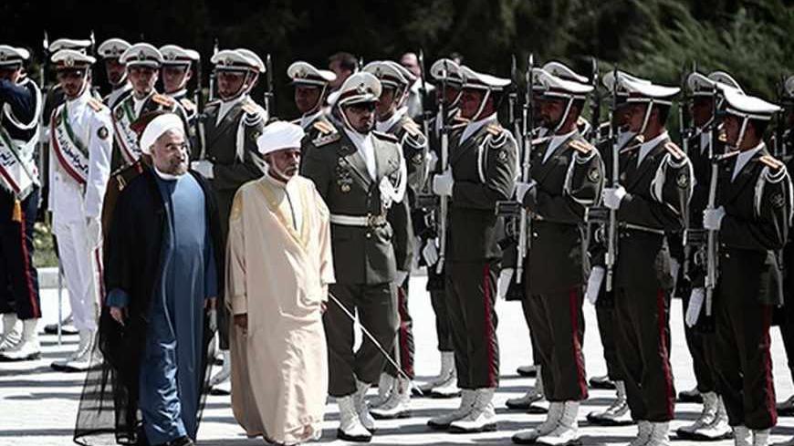Iranian President Hassan Rowhani (L) and Oman's Sultan Qaboos bin Said (C-R) review the honour guard during the latter's welcoming ceremony at Tehran's Saadabad Palace on August 25, 2013. The Iranian authorities have announced that Sultan Qaboos of Oman, the only Gulf leader to maintain good relations with Tehran, arrived in Iran for a focus on economic issues and diplomacy visit. AFP PHOTO/BEHROUZ MEHRI        (Photo credit should read BEHROUZ MEHRI/AFP/Getty Images)