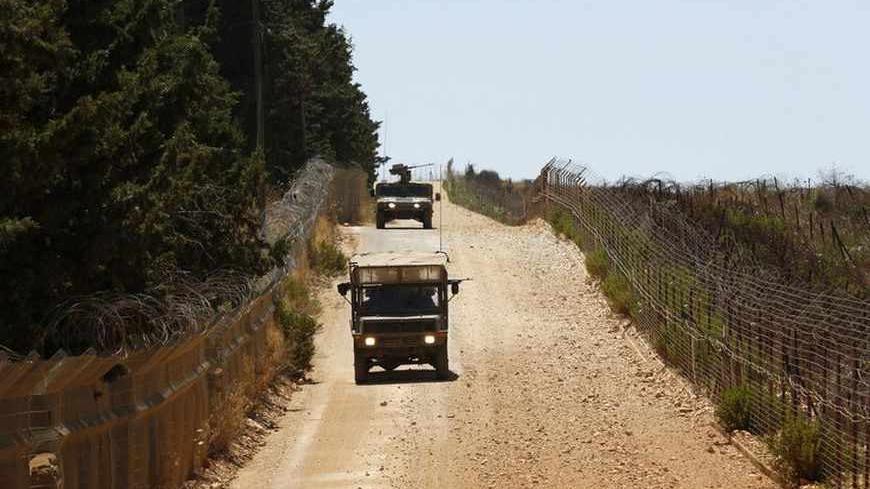 Israeli army vehicles patrol along Israel's border with Lebanon near the northern village of Avivim July 3, 2013. Israel is bolstering its forces on the once-quiet frontier with Syria where it believes Lebanese Hezbollah militants are preparing for the day when they could fight Israel. Picture taken July 3, 2013. REUTERS/Baz Ratner (ISRAEL - Tags: MILITARY POLITICS) - RTX11IMG