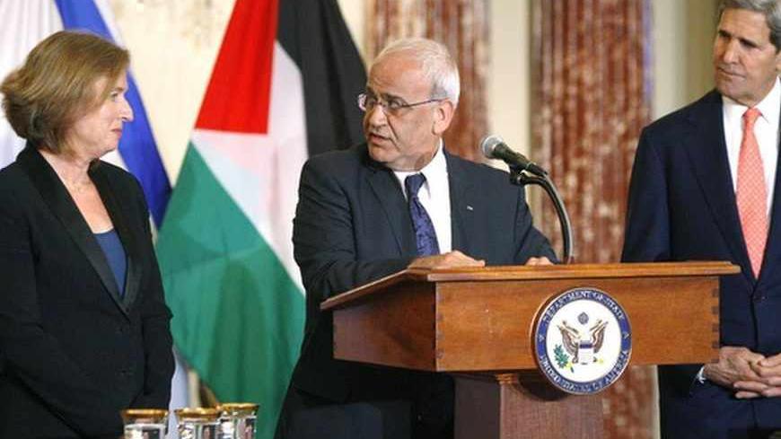 Chief Palestinian negotiator Saeb Erekat (C) directs remarks to Israel's Justice Minister Tzipi Livni (L) during a news conference with U.S. Secretary of State John Kerry (R) at the end of talks at the State Department in Washington July 30, 2013. Israeli and Palestinian negotiators held their first peace talks in nearly three years on Monday in a U.S.-brokered effort that Kerry hopes will end their conflict despite deep divisions. REUTERS/Jonathan Ernst    (UNITED STATES - Tags: POLITICS) - RTX124ZT