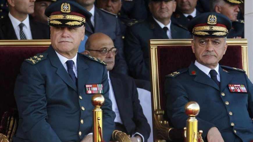 Lebanese Army Commander General Jean Kahwaji (L) and Army Chief of Staff General Walid Salman attend a graduation parade for Lebanese officer cadets at a military academy in Fayadyeh, near Beirut, marking the 68th Army Day, August 1, 2013.  Lebanon's defence minister extended the term of the army chief on Wednesday to avoid a vacuum in military leadership at a time when the country is facing violence linked to Syria's war and political paralysis. The extension by two years of Army Chief Jean Kahwaji's posti