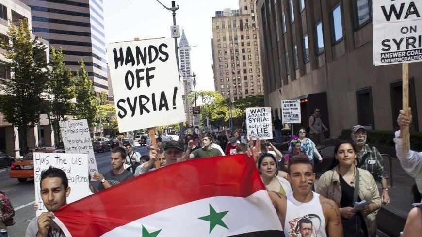 Protesters, including Syrian-Americans Memo Nakour (L) and Wes Nakour (R), demonstrate against potential strikes on the Syrian government in Seattle, Washington August 31, 2013. REUTERS/David Ryder  (UNITED STATES - Tags: POLITICS CIVIL UNREST) - RTX1333W