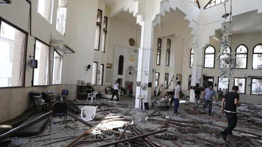 People inspect the damage inside one of two mosques hit by explosions in Lebanon's northern city of Tripoli, August 23, 2013. Twin explosions outside two mosques killed at least 27 people and wounded hundreds in apparently coordinated attacks in the northern Lebanese city of Tripoli on Friday, a senior health official and witnesses said. REUTERS/Mohamed Azakir  (LEBANON - Tags: POLITICS CIVIL UNREST) - RTX12U8I