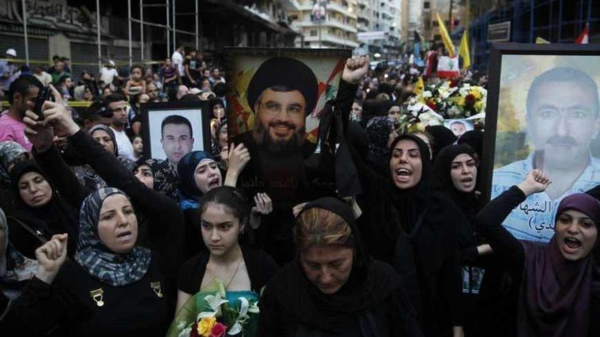 Lebanese civilians and supporters of Hezbollah take part in a candle light vigil in solidarity with people who died in a car bomb that occurred on last Thursday in Beirut's southern suburbs August 19, 2013. REUTERS/Sharif Karim (LEBANON - Tags: POLITICS CIVIL UNREST) - RTX12R0W