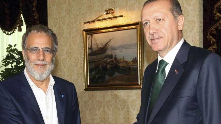 Turkey's Prime Minister Tayyip Erdogan (R) shakes hands with Yusuf Islam, formerly known as Cat Stevens, as they meet in Ankara August 2, 2013. REUTERS/Adem Altan/Pool (TURKEY - Tags: POLITICS ENTERTAINMENT) - RTX1288Q