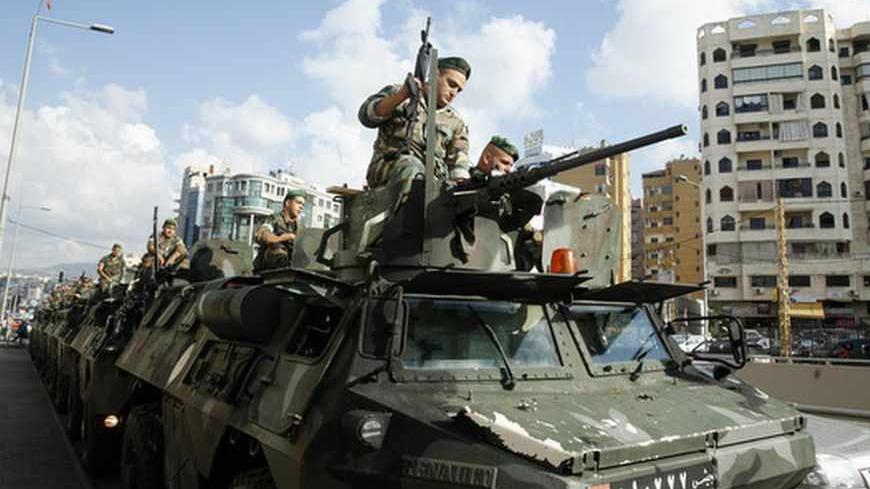 Lebanese army soldiers are deployed on their armoured vehicles in Beirut's southern suburbs September 23, 2013. Lebanese security personnel were deployed today in the southern suburbs of Beirut, part of a move to take over the checkpoints set up by Hezbollah after recent car bombings targeted the area, according to the local media. REUTERS/Sharif Karim (LEBANON - Tags: POLITICS CIVIL UNREST) - RTX13WWO