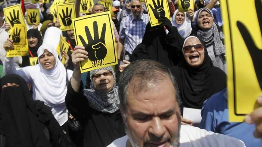 Members of the Muslim Brotherhood and supporters of ousted Egyptian President Mohamed Mursi shout slogans against the military and the interior ministry as they make the "Rabaa" or "four" gesture, in reference to the police clearing of Rabaa al-Adawiya protest camp on August 14, during a protest march towards El-Thadiya presidential palace in Cairo August 30, 2013. REUTERS/Amr Abdallah Dalsh  (EGYPT - Tags: POLITICS CIVIL UNREST) - RTX131HT