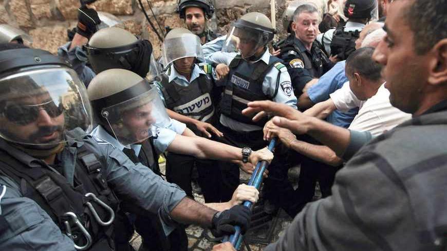 Israeli policemen attempt to maintain order during a demonstration by Palestinians near Lion's Gate in Jerusalem's Old City, as minor clashes take place at a nearby compound known to Muslims as Noble Sanctuary and to Jews as Temple Mount September 4, 2013. An Israeli police spokesperson said five people were detained on Wednesday for throwing stones at police who had entered the compound after stones were thrown at visitors at the holy site ahead of the Jewish new year, or Rosh Hashanah, which begins today 