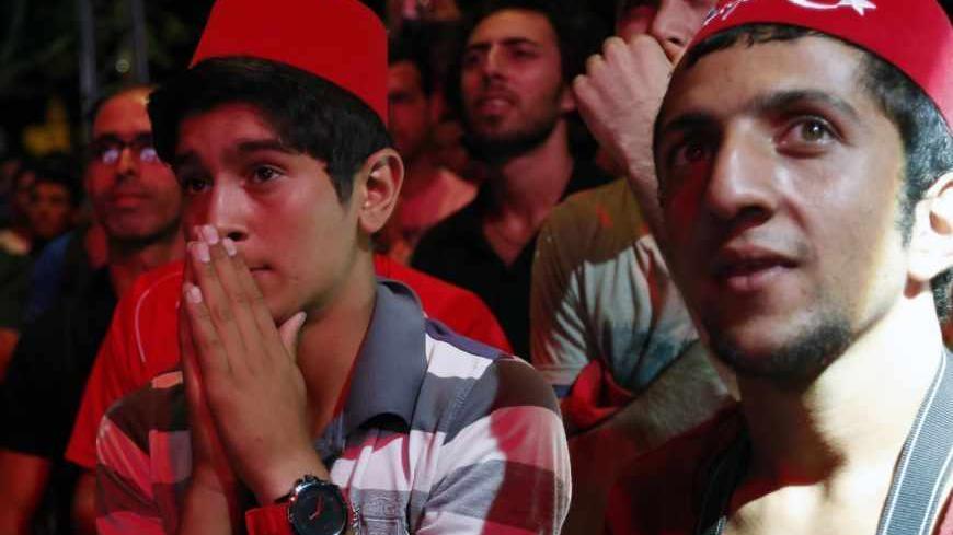 Turks react after finding out that Tokyo was awarded the right to host the 2020 Summer Games as they watch it live on big screens in Sultanahmet Square in Istanbul September 7, 2013.  REUTERS/Murad Sezer (TURKEY - Tags: SPORT OLYMPICS) - RTX13BZQ