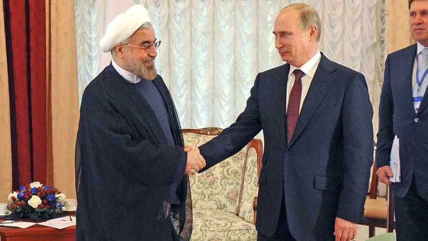 Russia's President Vladimir Putin (2nd L) shakes hands with his Iranian counterpart Hassan Rouhani (L) during a meeting at the Shanghai Cooperation Organization (SCO) summit in Bishkek, September 13, 2013. Rouhani said on Friday that he wanted a swift resolution to a dispute over Tehran's nuclear programme, which Western states fear is aimed at developing nuclear weapons. REUTERS/Mikhail Klimentyev/RIA Novosti/Kremlin (KYRGYZSTAN  - Tags: POLITICS) ATTENTION EDITORS - THIS IMAGE HAS BEEN SUPPLIED BY A THIRD