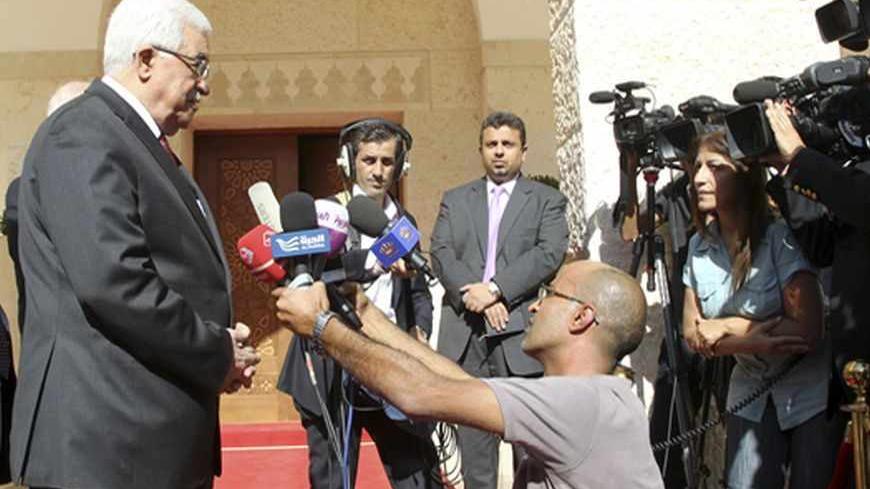 Palestinian President Mahmoud Abbas (L) speaks to the media after his meeting with Jordan's King Abdullah at the Royal Palace in Amman August 28, 2013. REUTERS/Muhammad Hamed (JORDAN - Tags: POLITICS ROYALS) - RTX12Z0D
