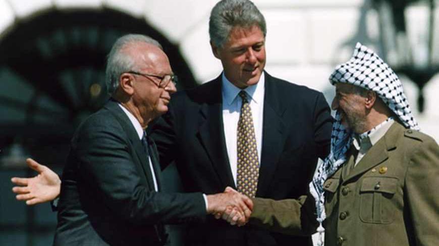 President Clinton brings Israeli Prime Minister Yitzhak Rabin (L) and PLO Chairman Yasser Arafat together for an historic handshake after the signing of the Israeli-PLO peace accord at the White House Sept. 13 - RTXEYZ7