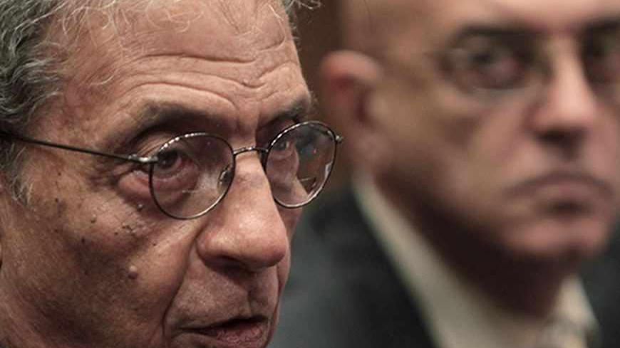 Amr Moussa (L), chairman of the committee to amend the country's constitution speaks at a news conference, next to media spokesperson Mohamed Salmawy, at the Shura Council in Cairo September 22, 2013. Moussa has been selected to chair the committee entrusted with amending the constitution pushed through by deposed Islamist president Mohamed Mursi.        REUTERS/Mohamed Abd El Ghany  (EGYPT - Tags: POLITICS) - RTX13UNS