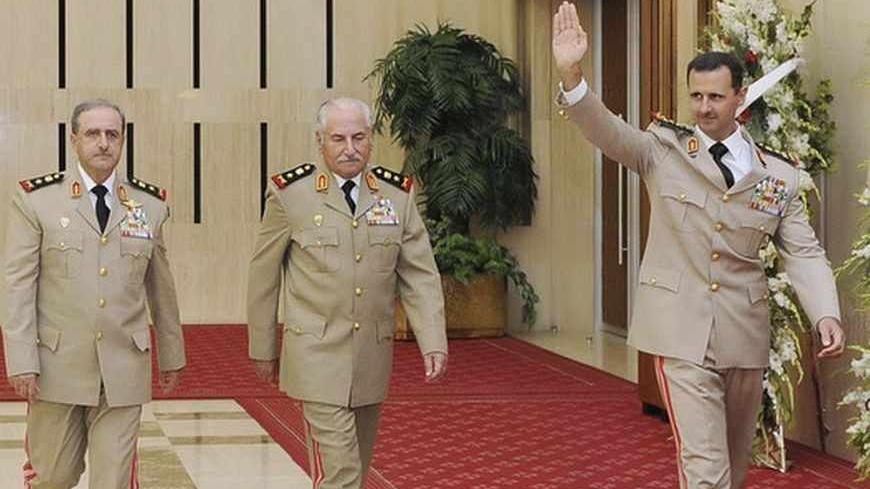 Syria's President Bashar al-Assad (R) waves as he arrives with Syrian Defense Minister General Ali Habib (C) and Chief of Staff General Dawoud Rajha to attend a dinner to honour army officers on the 65th Army Foundation anniversary in Damascus August 1, 2010. REUTERS/Sana (SYRIA - Tags: ANNIVERSARY POLITICS MILITARY) - RTR2GZ1H