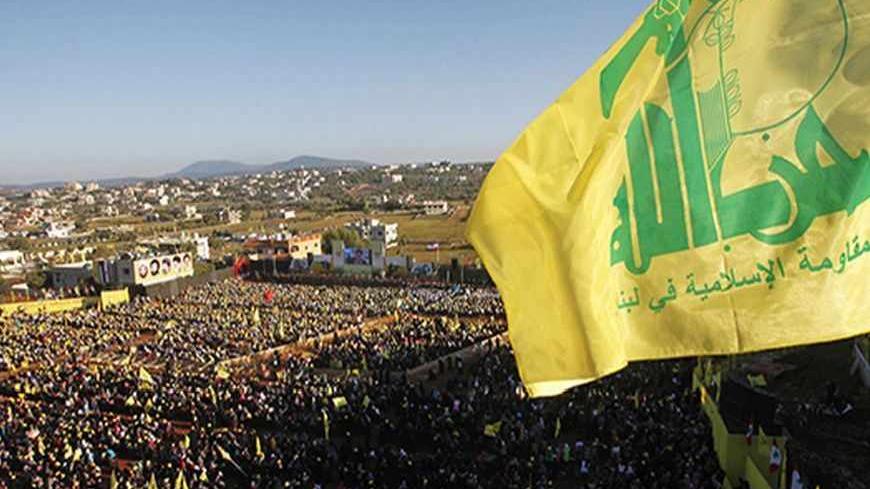 Supporters of Lebanon's Hezbollah leader Sayyed Hassan Nasrallah wave Hezbollah flags as they listen to him via a screen during a rally on the 7th anniversary of the end of Hezbollah's 2006 war with Israel, in Aita al-Shaab village in southern Lebanon, August 16, 2013. Nasrallah renewed his commitment on Friday to the battle in Syria, where the Shi'ite militant group has been fighting alongside President Bashar al-Assad's forces, saying he was ready to go himself if needed. REUTERS/Ali Hashisho    (LEBANON 
