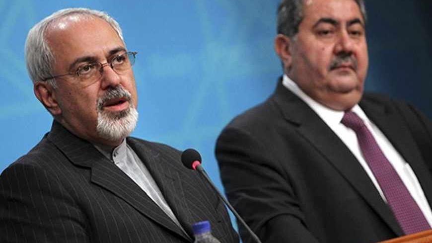 Iranian Foreign Minister Mohammad Javed Zarif (L) speaks during a joint news conference with his Iraqi counterpart Hoshyar Zebari in Baghdad, September 8, 2013. The United States will ignite a fire across the Middle East if it attacks Syria, Zarif said on a visit to Iraq on Sunday, warning Western powers against warmongering. REUTERS/Ahmad Al-Rubaye/Pool (IRAQ - Tags: POLITICS) - RTX13CUF