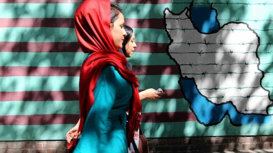 Iranian women walk past a mural showing an interpretation of the Statue of Liberty bearing the face of a skull on the wall of the former US embassy in Tehran on September 25, 2013. Leaders from Iran and the United States have not met since the 1979 Islamic Revolution brought often open hostility to their contacts, particularly over Iran's contested nuclear program.  AFP PHOTO/ATTA KENARE        (Photo credit should read ATTA KENARE/AFP/Getty Images)