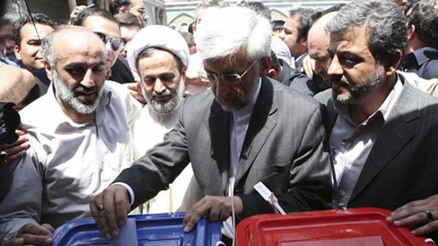 Presidential candidate Saeed Jalili (C) casts his ballot during the Iranian presidential election in Tehran June 14, 2013. Millions of Iranians voted to choose a new president on Friday, urged by Supreme Leader Ayatollah Ali Khamenei to turn out in force to discredit suggestions by arch foe the United States that the election would be a sham. REUTERS/Fars News/Armin Karami  (IRAN - Tags: POLITICS ELECTIONS) ATTENTION EDITORS - THIS IMAGE WAS PROVIDED BY A THIRD PARTY. FOR EDITORIAL USE ONLY. NOT FOR SALE FO