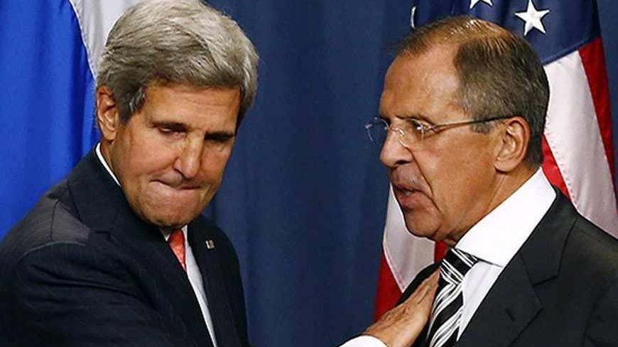 U.S. Secretary of State John Kerry (L) and Russian Foreign Minister Sergei Lavrov shake hands after making statements following meetings regarding Syria, at a news conference in Geneva September 14, 2013. The United States and Russia have agreed on a proposal to eliminate Syria's chemical weapons arsenal, Kerry said on Saturday after nearly three days of talks with Lavrov.  REUTERS/Ruben Sprich (SWITZERLAND - Tags: POLITICS) - RTX13KX7