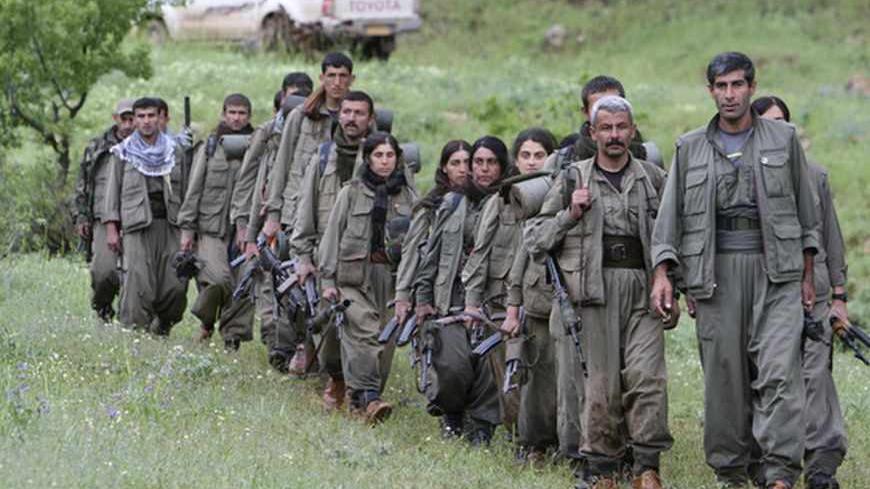 Kurdistan Workers Party (PKK) fighters walk on the way to their new base in northern Iraq May 14, 2013. The first group of Kurdish militants to withdraw from Turkey under a peace process entered northern Iraq on Tuesday, and were greeted by comrades from the Kurdistan Workers Party (PKK), in a symbolic step towards ending a three-decades-old insurgency. The 13 men and women, carrying guns and with rucksacks on their backs, arrived in the area of Heror, near Metina mountain on the Turkish-Iraqi border, a Reu