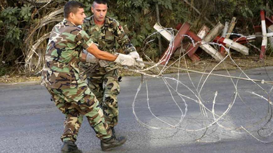 Lebanese army soldiers install barbed wire to close a road leading to the U.S. embassy in Awkar, north of Beirut, before a protest against potential U.S. strikes on Syria, September 7, 2013. U.S. officials ordered non-emergency personnel and their family members out of Lebanon on Friday "due to threats," the U.S. embassy in Beirut said in a statement. REUTERS/Hasan Shaaban (LEBANON - Tags: POLITICS CIVIL UNREST MILITARY) - RTX13BL1