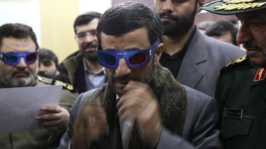Iranian President Mahmoud Ahmadinejad wears 3-D glasses to watch a programme about an Iranian rocket during a visit to the control centre for Iran's space programme near Tehran February 4, 2008. Iran launched a rocket on Monday designed to send its first homemade research satellite into orbit in the next year, state television said, a move likely to add to Western concerns about Tehran's nuclear plans.  REUTERS/Fars News (IRAN)   also see GF2DXFSYXNAA - RTR1WNQL