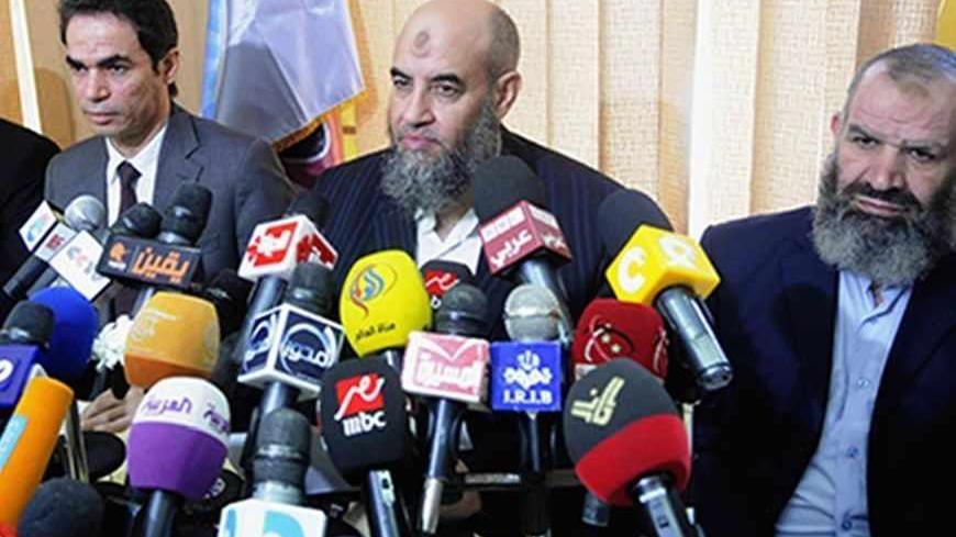 Younes Makhyoun (2nd R), head of the Salafist al-Nour Party attends a news conference with Presidential Media Advisor and spokesman Ahmed al-Muslimani (2nd L) at the party's headquarters in Cairo August 28, 2013. During the conference, Makhyoun stated that the Egyptian armed forces are a red line and reiterated al-Nour's support of the army's roadmap back to democracy, according to local media. Picture taken August 28, 2013.  REUTERS/Stringer  (EGYPT - Tags: POLITICS MEDIA) - RTX12ZWG