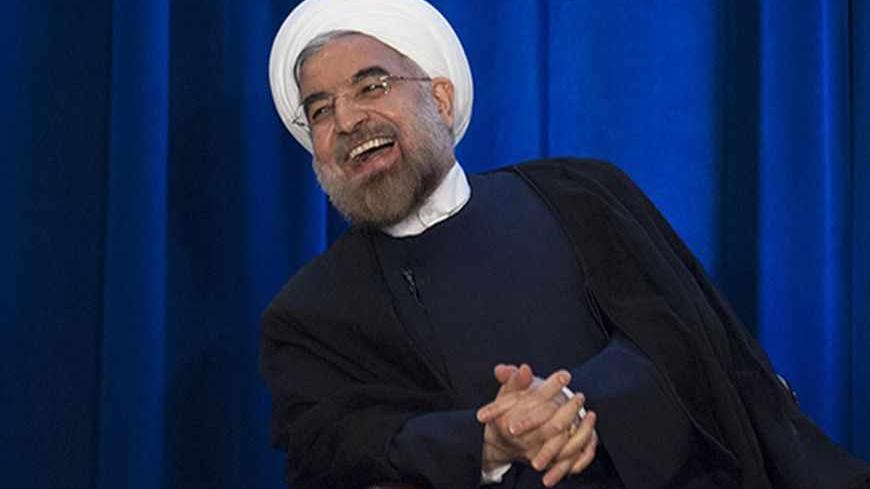 Iran's President Hassan Rohani laughs as he speaks during an event hosted by the Council on Foreign Relations and the Asia Society in New York, September 26, 2013.  REUTERS/Keith Bedford (UNITED STATES - Tags: POLITICS) - RTX14198