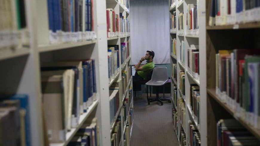 A student sits in a library at the Ariel University Centre in the West Bank Jewish settlement of Ariel September 13, 2012. An Israeli government move to upgrade Ariel University Centre in the occupied West Bank to a full-fledged university has put the 30-year-old school at the centre of a debate at the core of the Israeli-Palestinian conflict: how the settlements will figure in defining a future Palestinian state. Picture taken September 13, 2012. To match Feature PALESTINIANS-ISRAEL/SETTLEMENTS     REUTERS